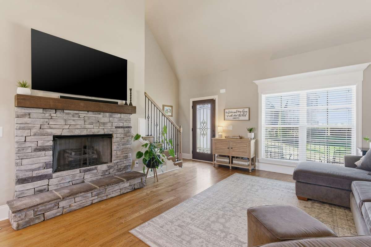 The stoned fireplace and wood mantle feature a raised hearth for extra seating.