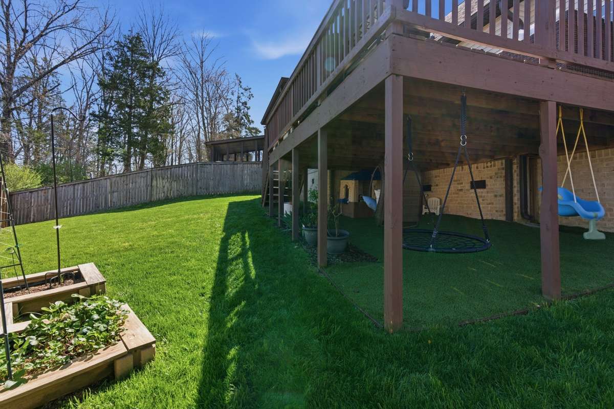 This area under the deck was turfed for a clean area for swings for the kids and their outdoor toys.