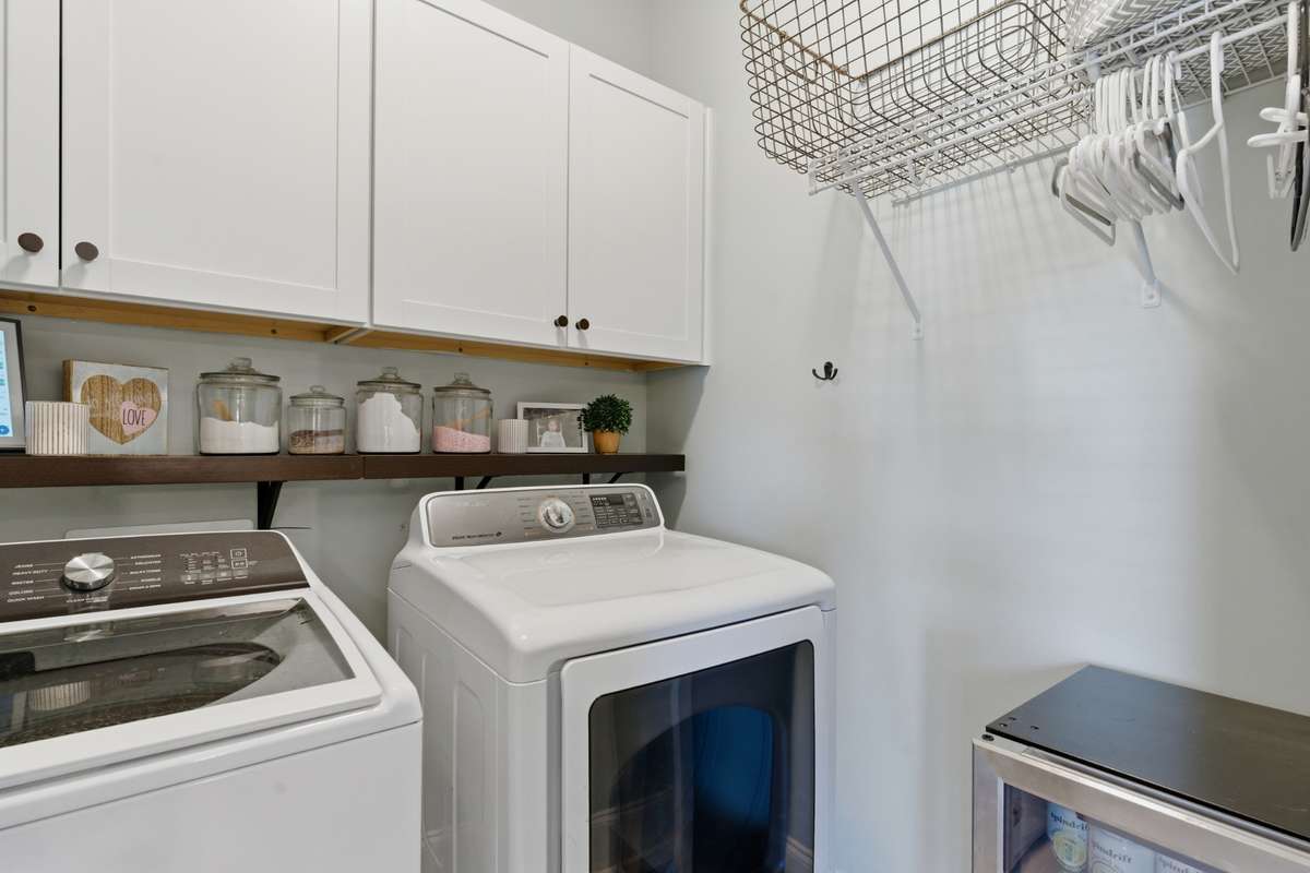 The main floor laundry room has cabinetry for great storage.