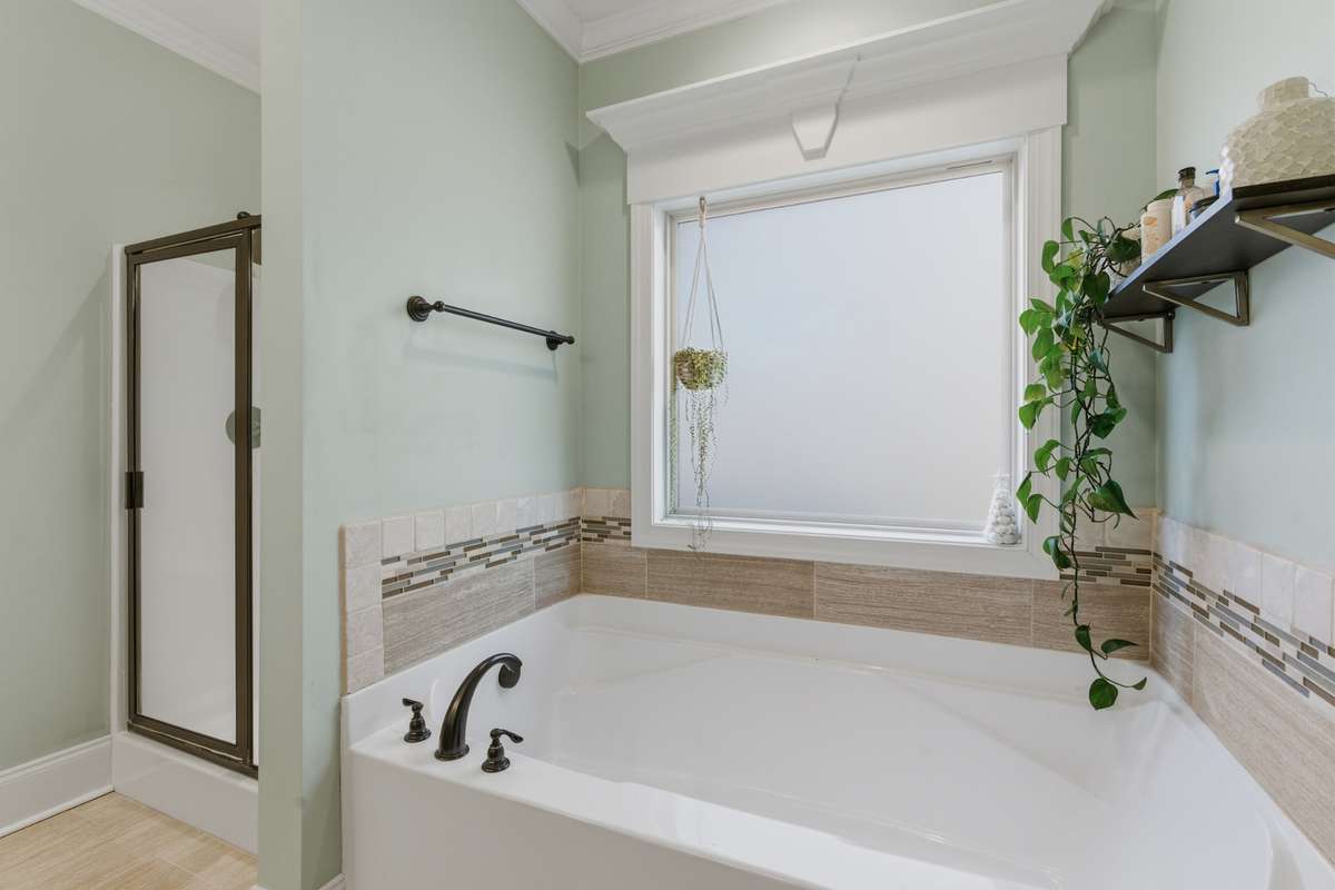 A large bath where you can soak and a separate shower are welcomed features, as well as a large obscured glass window for natural lighting.