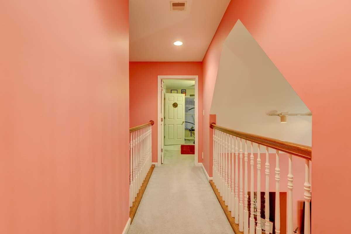 catwalk open to downstairs leading to another bedroom & an office