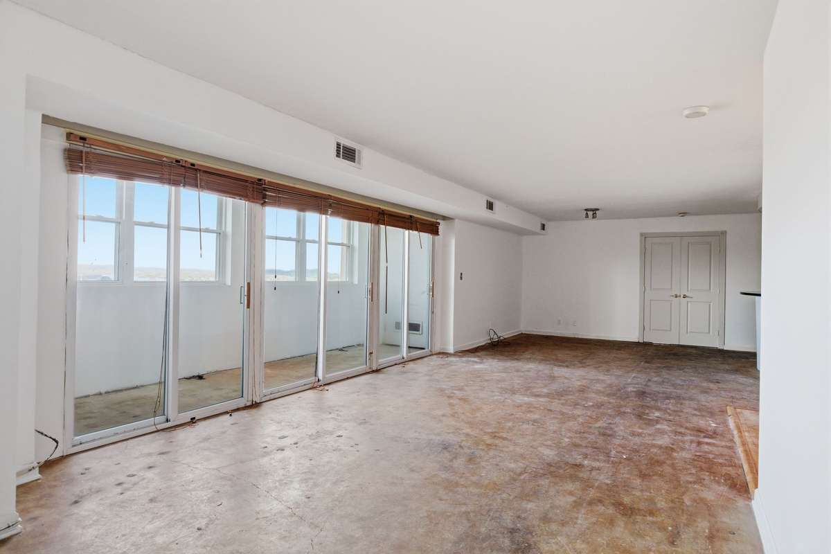 Living and dining room. Double doors are primary suite.
