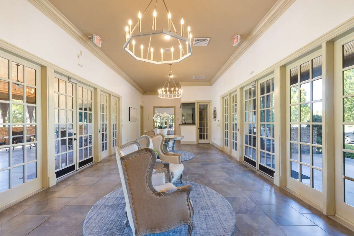 The Clubhouse hosts entertaining areas and the gym....but this center hallway divides the two beautifully and opens up to the covered patio area with fireplace...