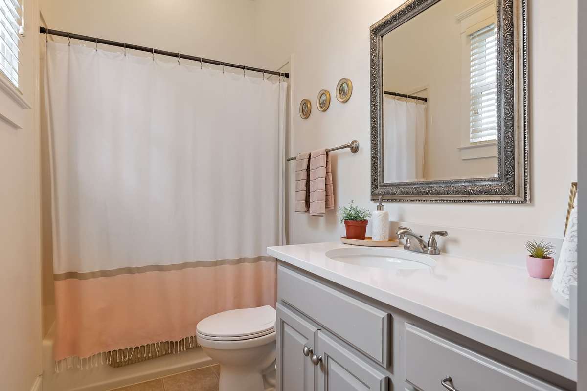 Beautiful shower/tub combo with new quartz countertops....
