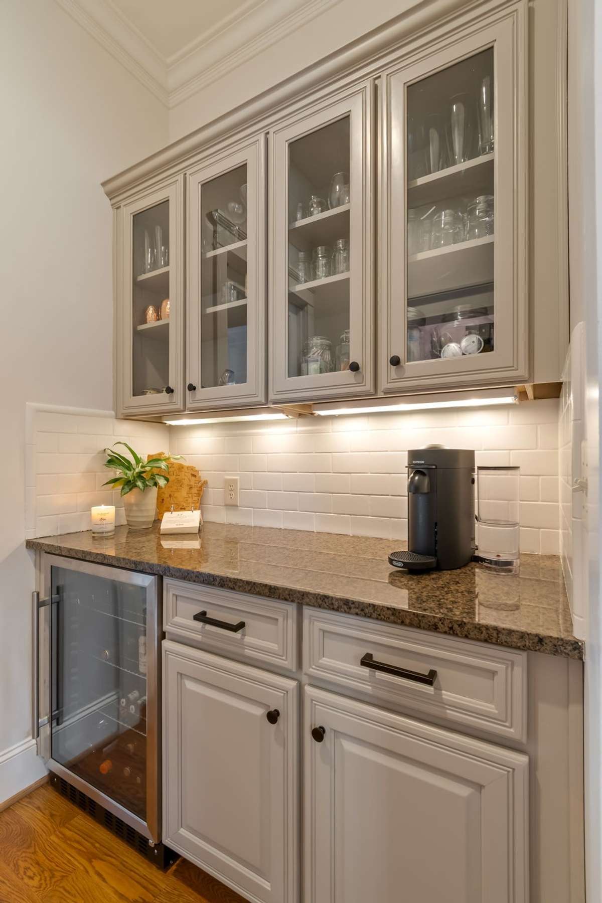 The Butler's Pantry hosts a beverage fridge and beautiful glass front cabinetry...