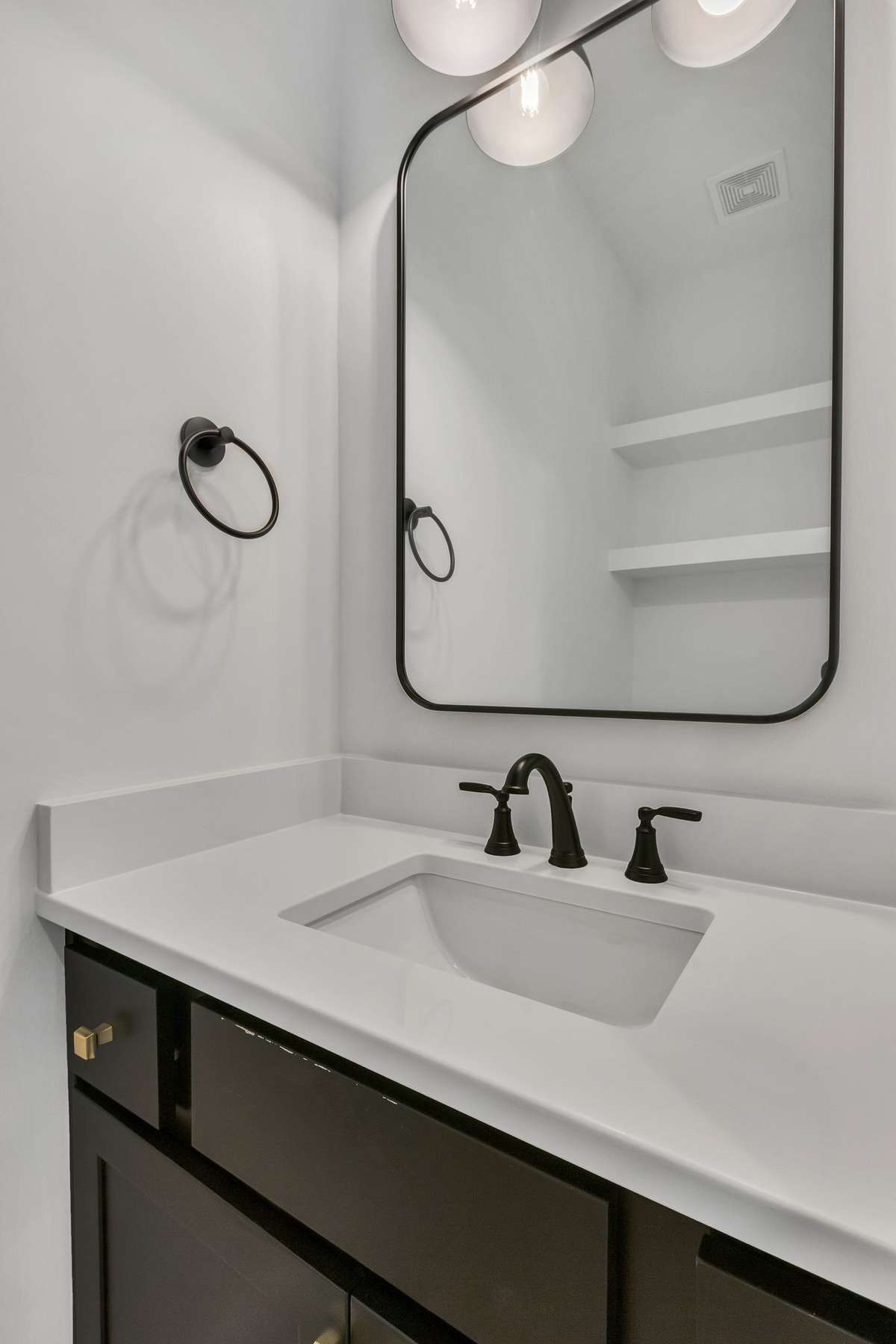 Photo of a previous built Ensley home. Shown for illustration purposes only. Materials and finishes will vary. Ask listing agent for included features on this home. Mirror will be different than shown in photo. Half bath downstairs.