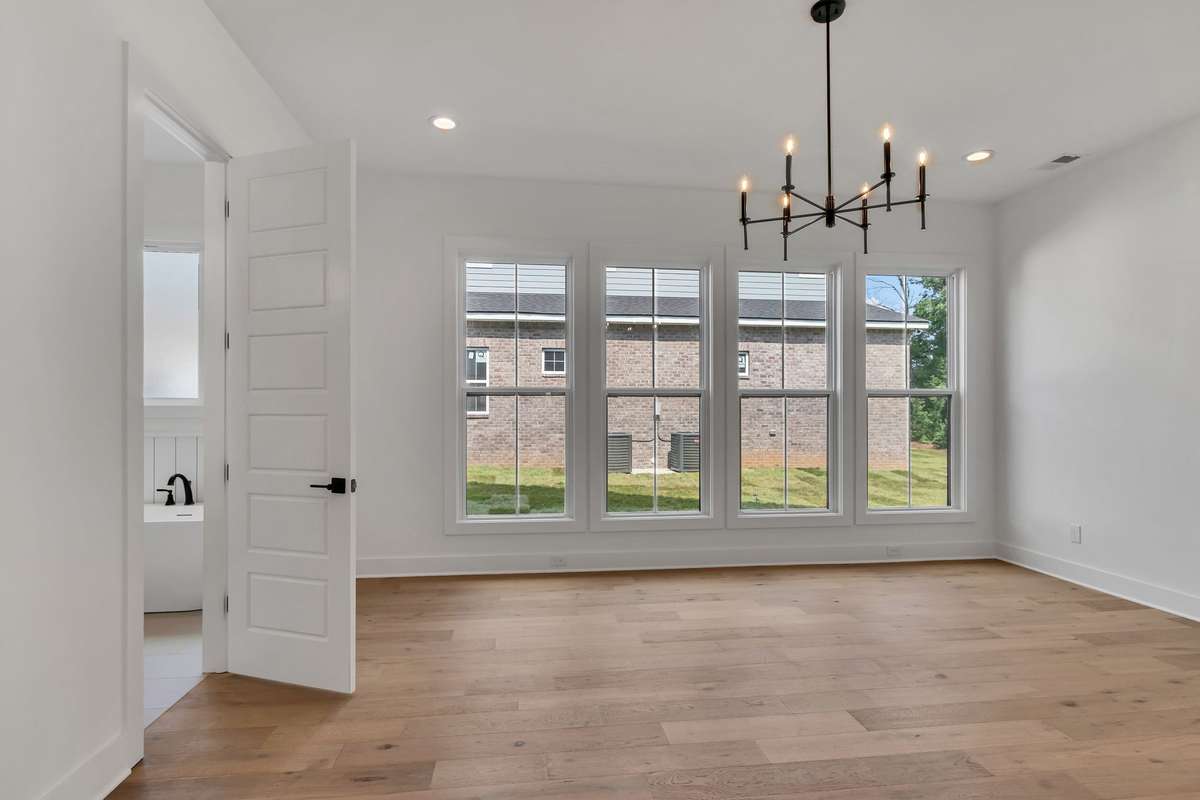 Photo of a previous built Ensley home. Shown for illustration purposes only. Materials and finishes will vary. Ask listing agent for included features on this home. Primary bedroom. Light fixtures will vary on lot 47 Brewer Point from photo.