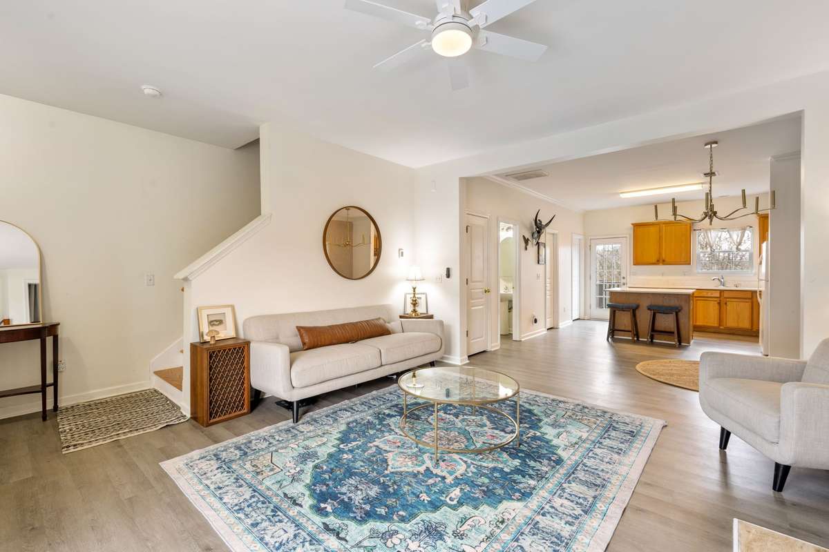 Inviting living room space with a gas-log fireplace, luxury vinyl plank flooring, lots of natural light, and an open floor plan.