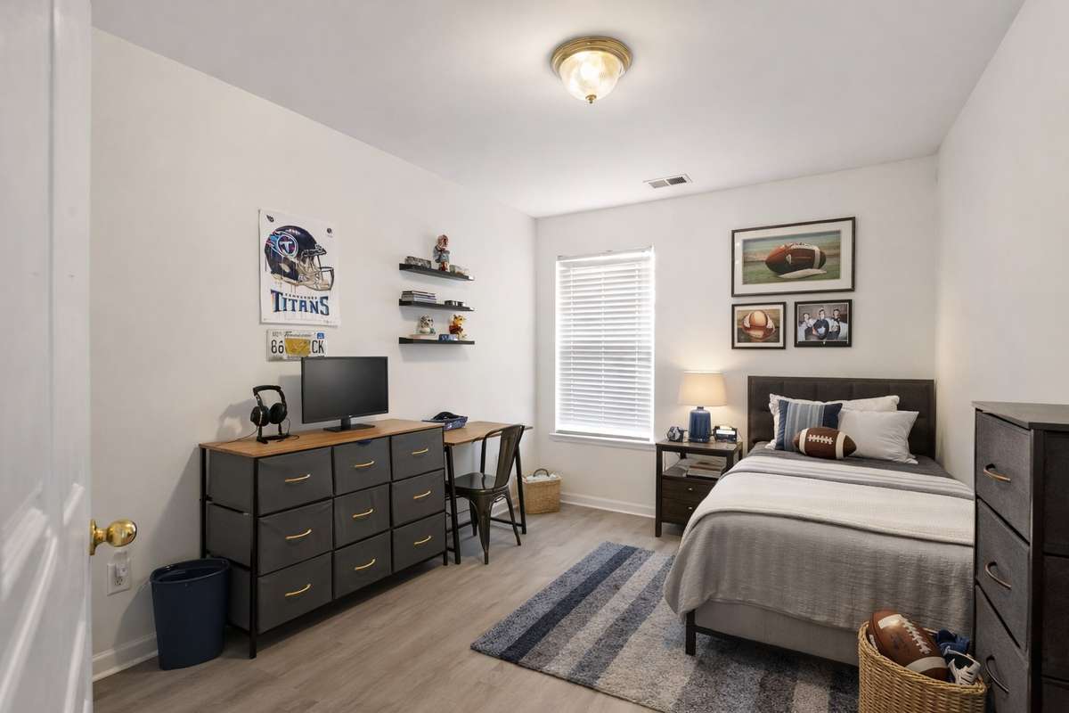 Both secondary bedrooms have LVP floors and share the hallway full bathroom. (Virtually staged.)