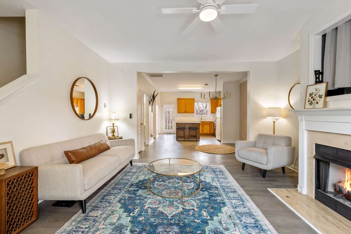 Inviting living room space with a gas-log fireplace, lots of natural light, and an open floor plan.