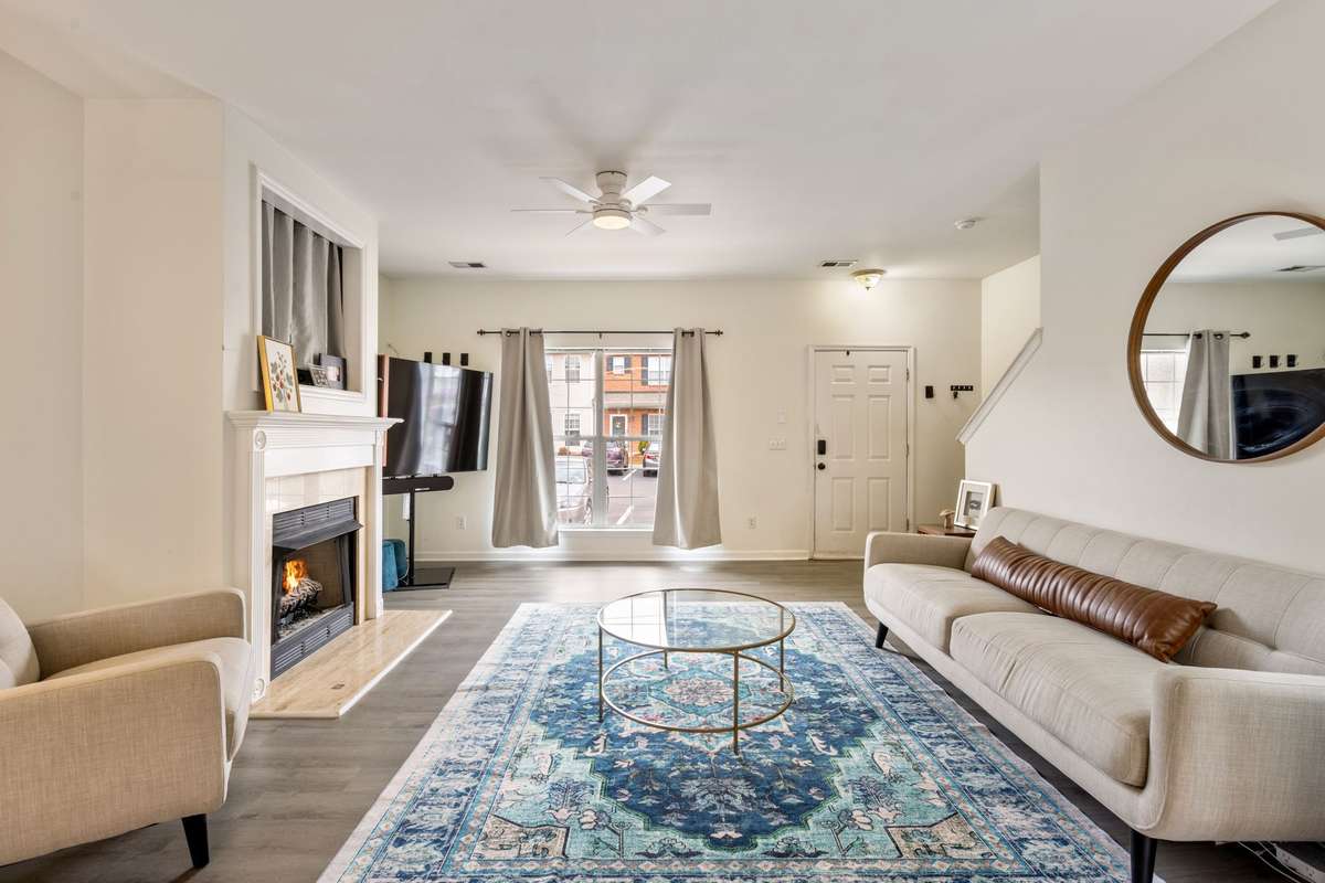 Inviting living room space with a gas-log fireplace, lots of natural light, and an open floor plan.