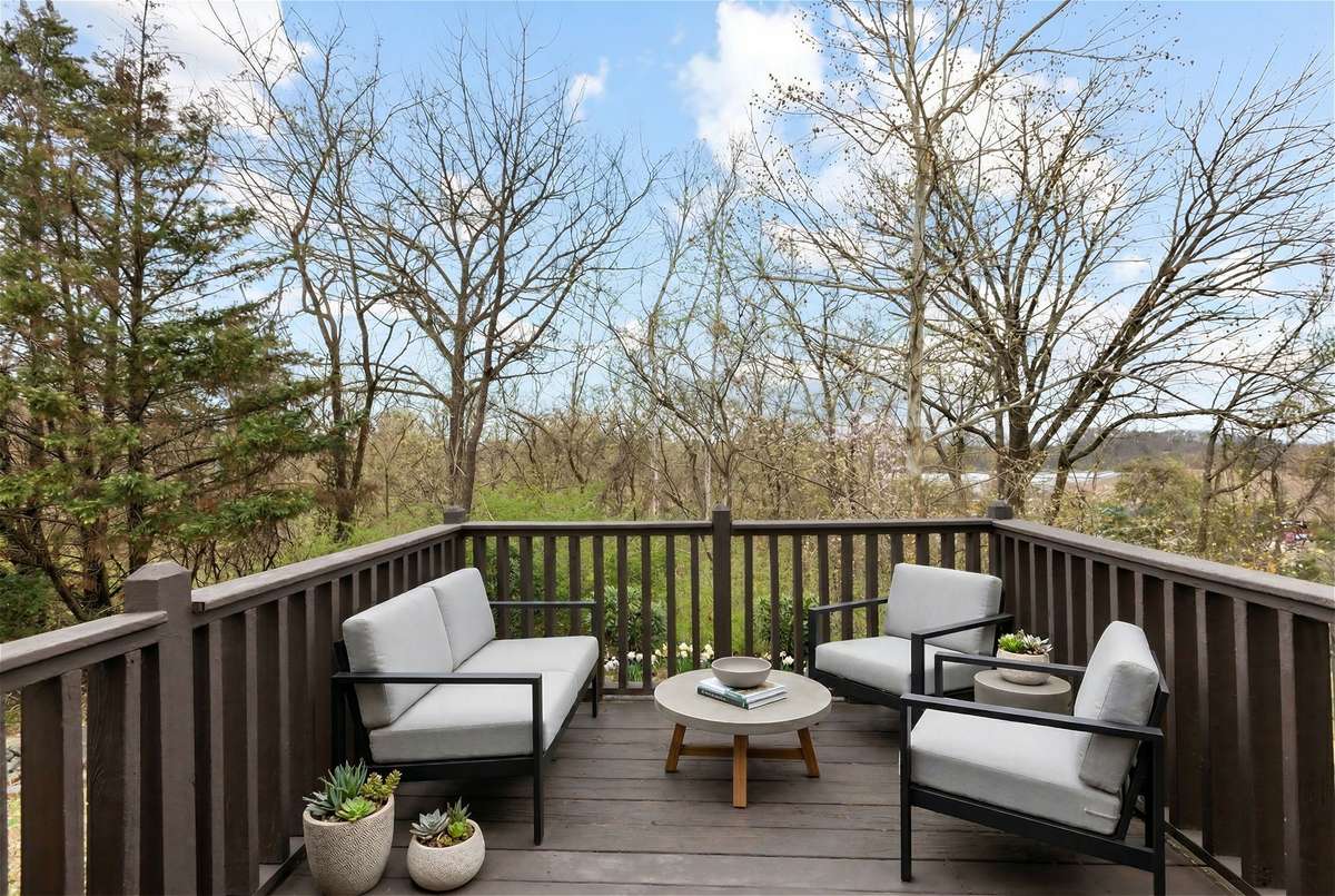 Back deck overlooks treetops and greenspace. (Virtually staged.)