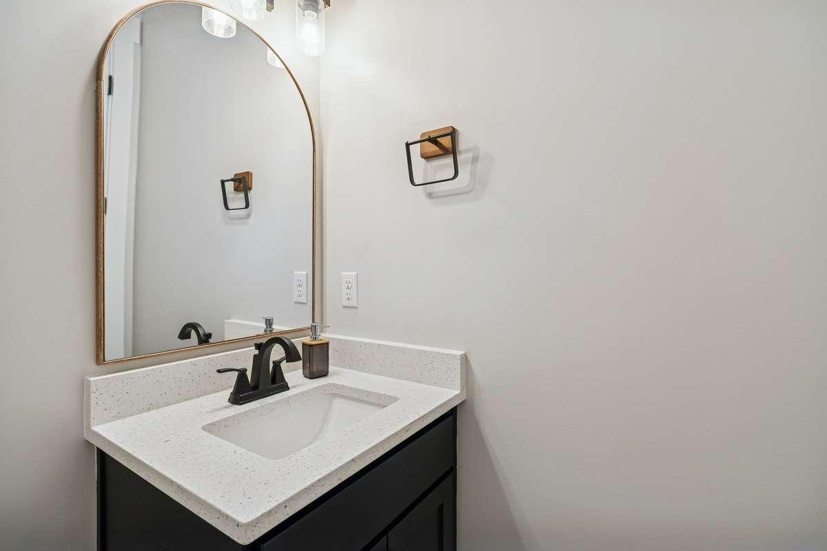 This half bath features a single vanity & modern mirror. 763 Thompson Creek Rd. Shelbyville, TN 37160