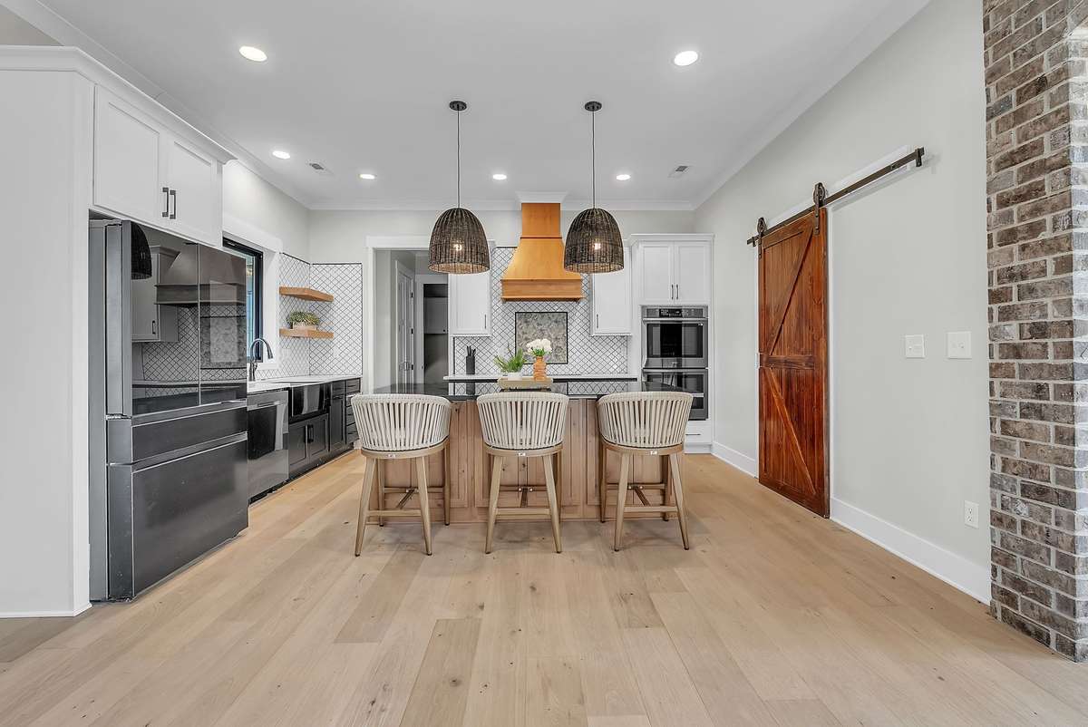 Step into your chef's dream kitchen with crown molding, recessed lights, & sliding barn door. 763 Thompson Creek Rd. Shelbyville, TN 37160