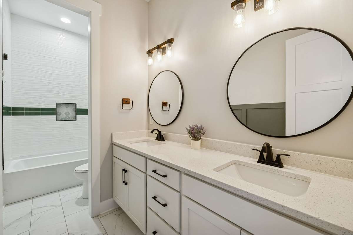 Guest bathroom with double vanity & tile flooring. 763 Thompson Creek Rd. Shelbyville, TN 37160