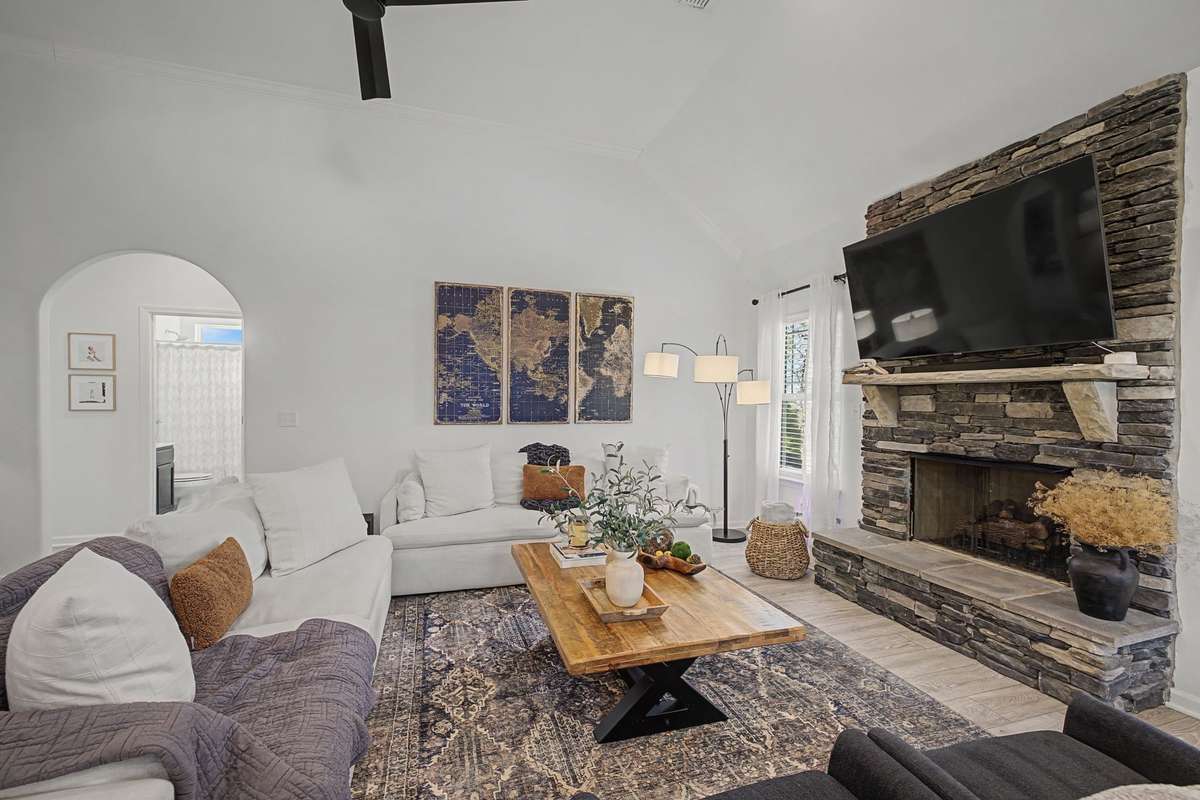 Gorgeous Great Room with laminate flooring and gas fireplace. Archway off the Great Room that leads to 2 of the 3 Downstairs Bedrooms.