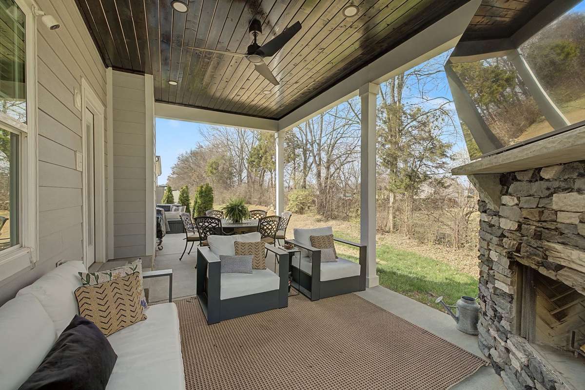 Gorgeous Covered Back Patio with Stained Wood Ceiling with  Recessed lighting and Ceiling Fan.