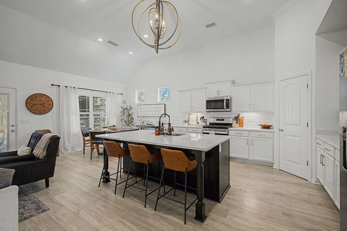 Amazing Kitchen with Huge Island, Stainless Steel Appliances, Gas Cooktop and Oven, Beautiful backsplash and solid surface countertops. Cabinets with Under cabinet lighting.