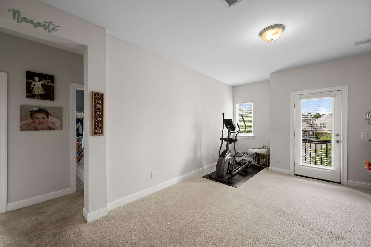 The versatile loft or bonus room offers an ideal secondary living area for lounging, work, or play.