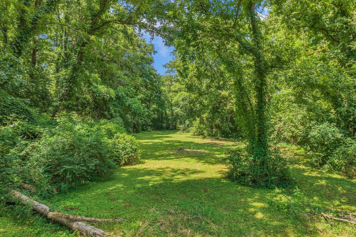 Down the hill from behind the house is a clearing that back ups to the creek that has loads of potential!