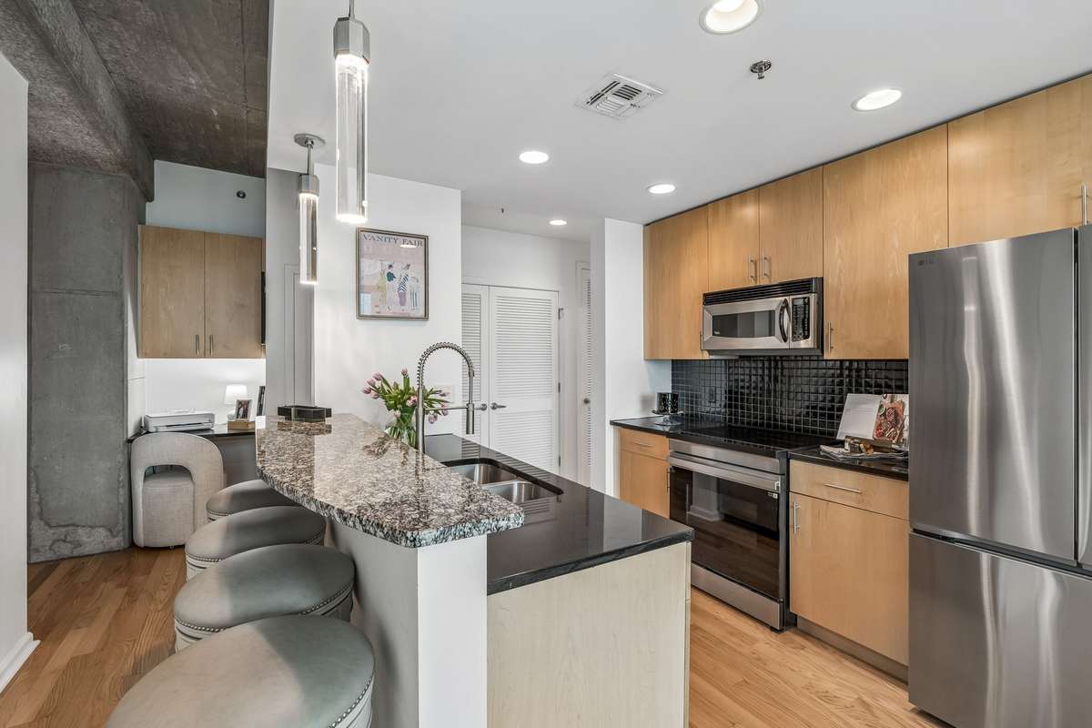 Kitchen with Personal Desk and Laundry Closet in Hallway