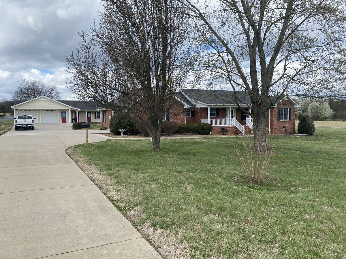 Concrete drive that extends to home and detached building.