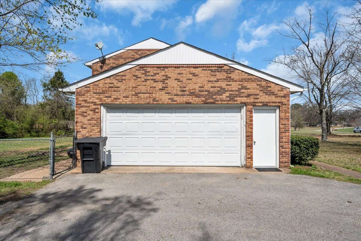 Oversized attached garage equipped with cabinetry, countertops, sink, and workspace, which is ideal for organization and projects. Could be converted into an XL Primary suite