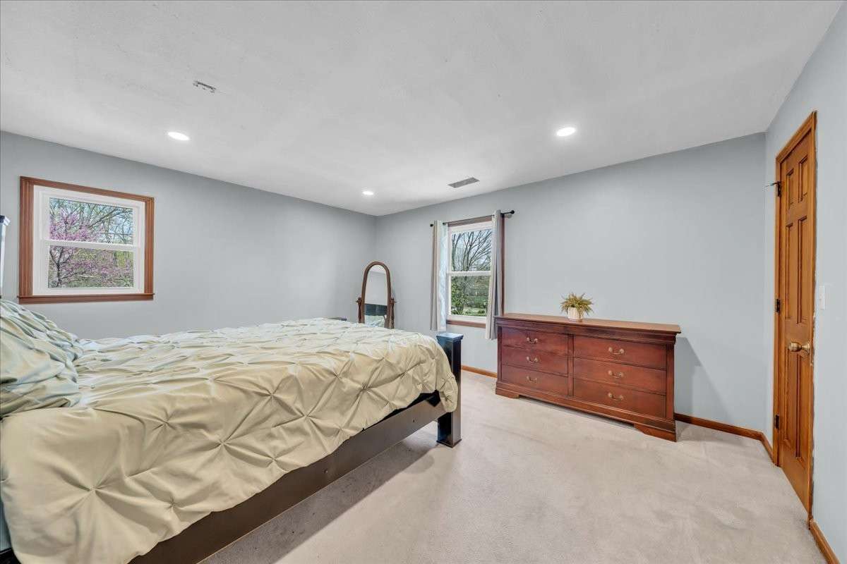 Spacious primary bedroom offering comfort and privacy with ample room for furnishings.