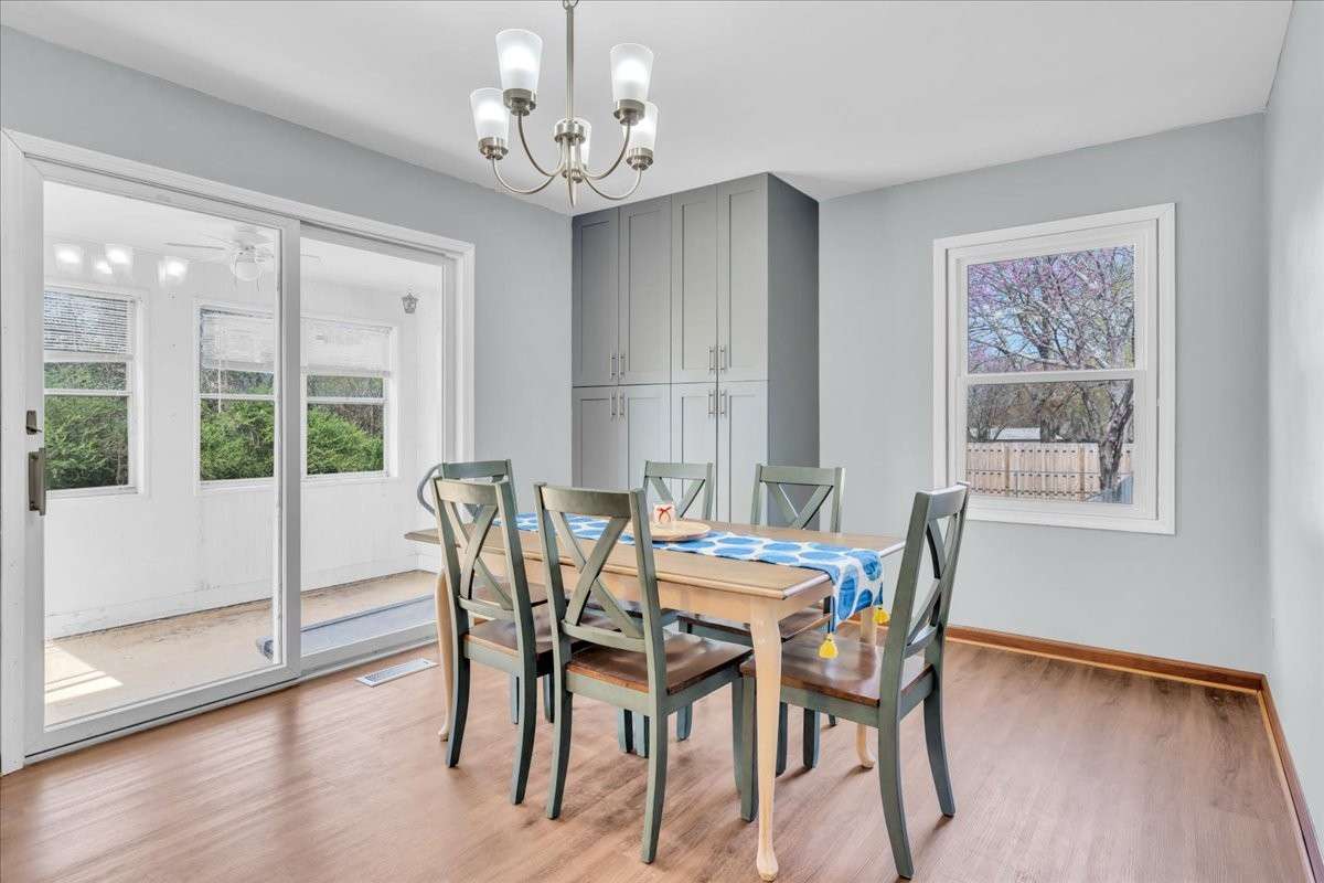 Bright dine-in kitchen space with ample room for gatherings, enhanced by custom cabinetry and functional layout.