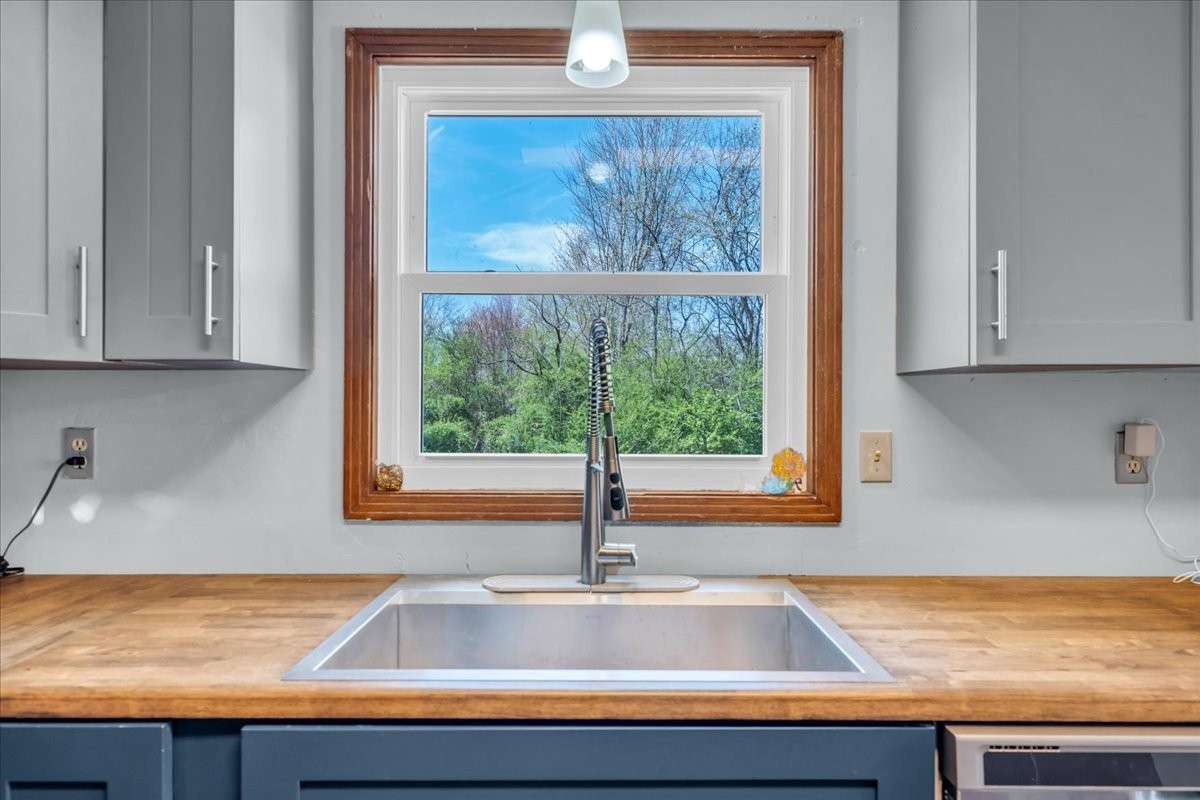 Spacious kitchen showcasing a farmhouse sink, double oven, and ample prep space.
