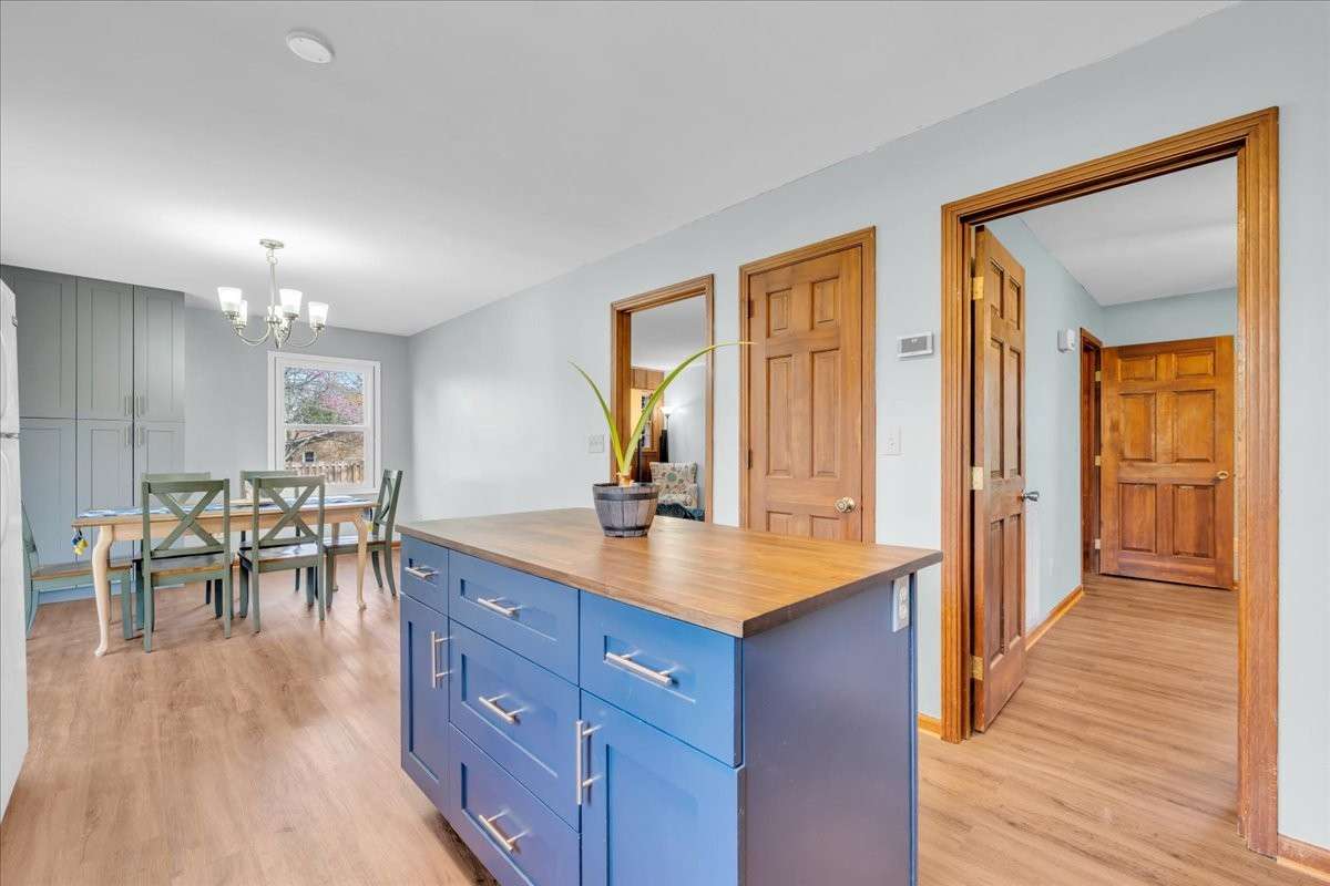 Spacious custom island with integrated chopping board adds both function and convenience to the kitchen.