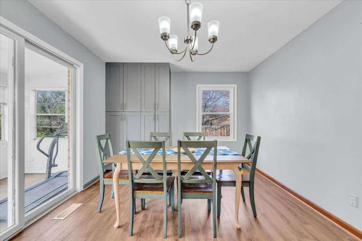 Bright dine-in kitchen space with ample room for gatherings, enhanced by custom cabinetry and functional layout.