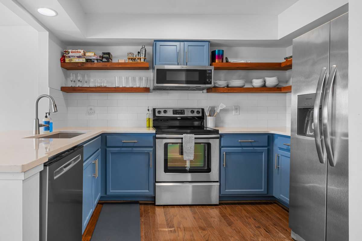 The Kitchen has been remodeled with open shelving and painted cabinets. A new stainless steel refrigerator has been installed since the pictures were made. The new refrigerator does not have water and ice in the door.