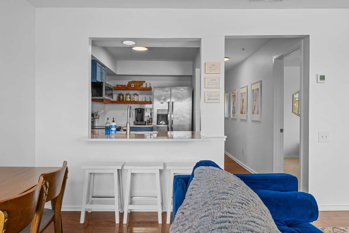 The Kitchen remodel included opening the bar area to overlook the living/dining space, adding additional seating for guests! A new stainless steel refrigerator has been installed since the pictures were made but does not have water/ice in the door.