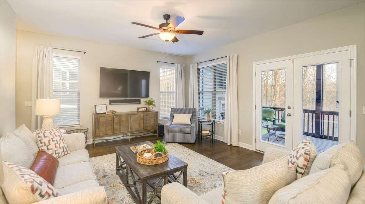 BLight and bright family room that leads to the screened in back porch.