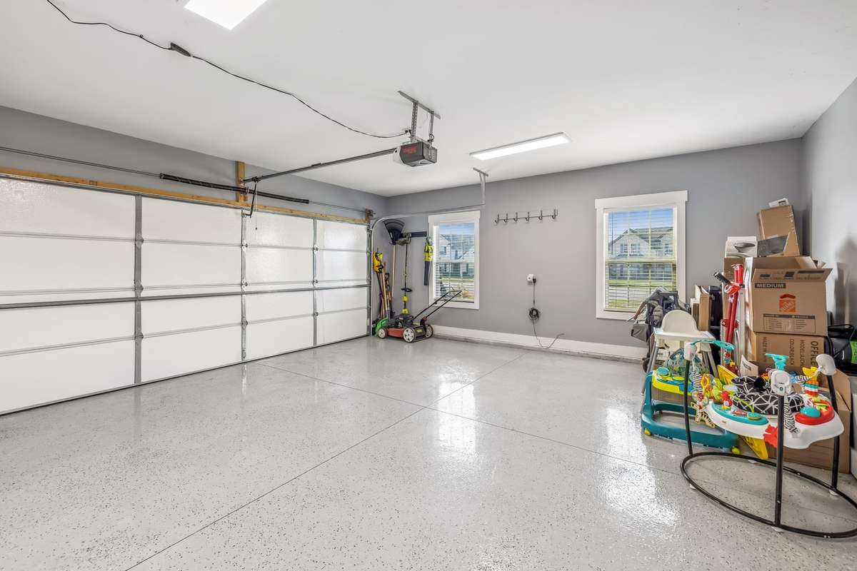 2 CAR GARAGE WITH NEW EPOXY GARAGE FLOOR, PLUS A PEDESTRIAN DOOR! THIS COULD HOUSE SOME WORKOUT EQUIPMENT, KEEP THE TOOLS ORGANIZED OR PARK TWO VEHICLES.