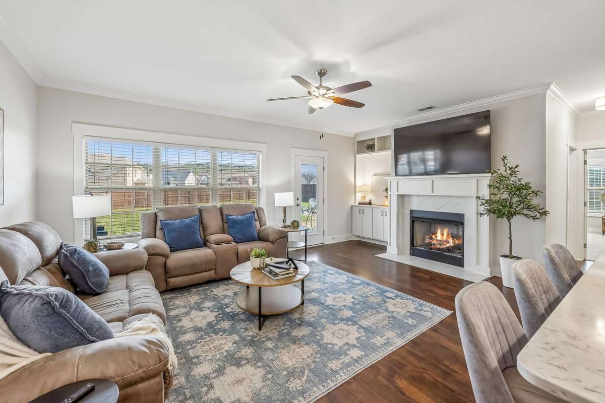 THE HARDWOODS, BUILT-INS AND THE FIREPLACE MAKE THIS GREAT ROOM WARM AND COZY!