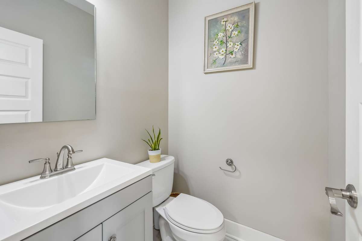 GUEST HALF BATH IN THE HALL OFF THE LIVING ROOM