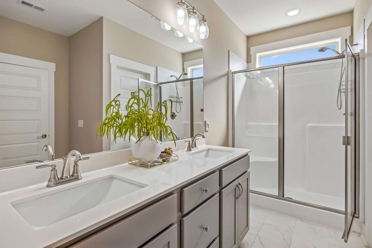 THE OWNER'S BATH IS JUST AS GORGEOUS-I LOVE THE TILE FLOORS, RECTANGLE SINKS, NATURAL LIGHT FROM THE TRANSOM WINDOW AND DOUBLE SIZED SHOWER!