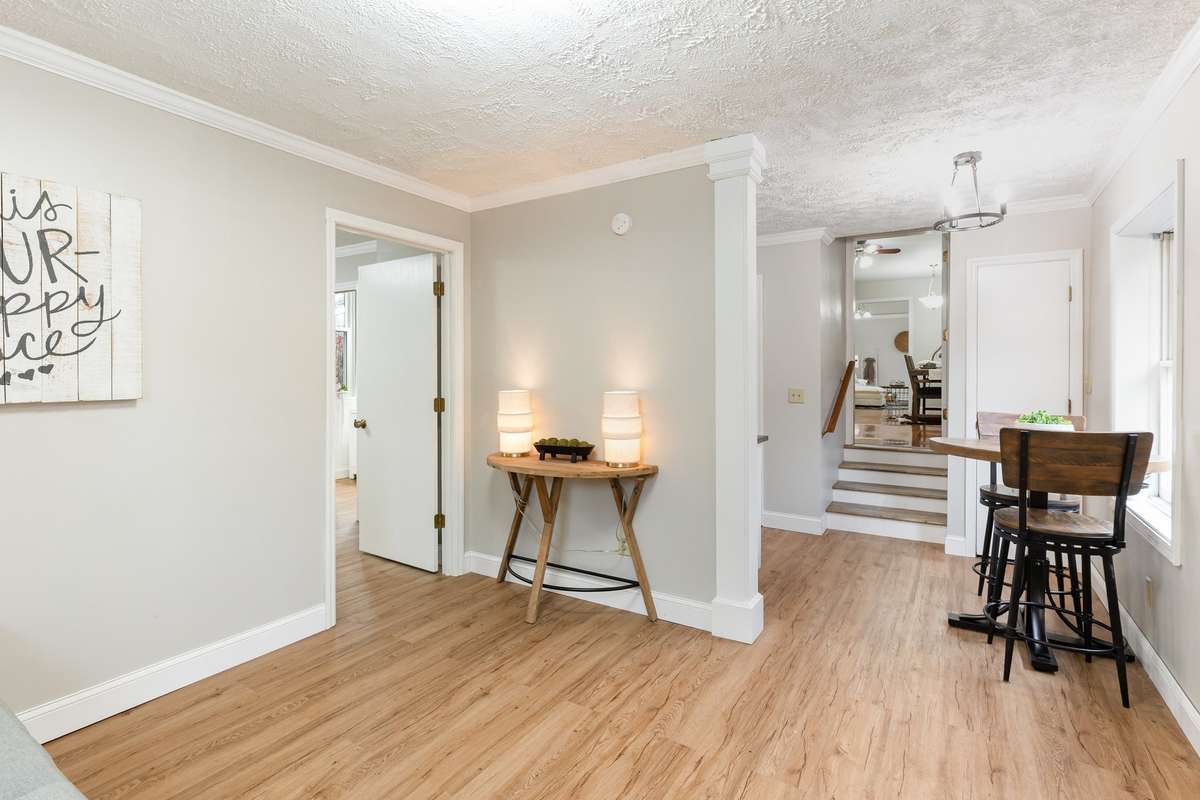 From the living room of the mother-in-law suite, you're met with a bright and open view into the charming eat-in kitchen.