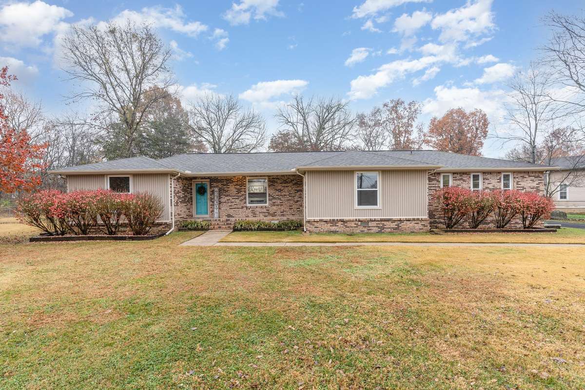 Home located in the desirable Weakley Hills neighborhood with colorful shrubs that enhance curb appeal
