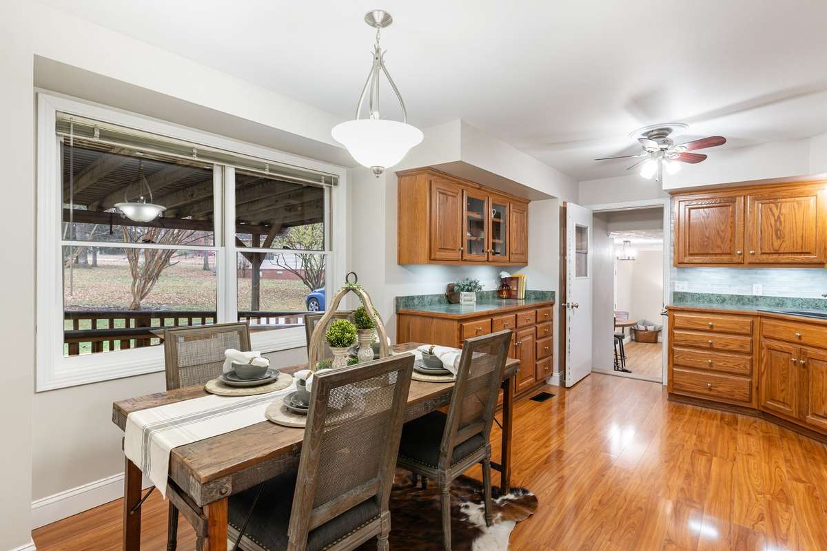 Spacious eat-in Kitchen featuring large windows that bring in excellent natural light and offer views of the covered porch
