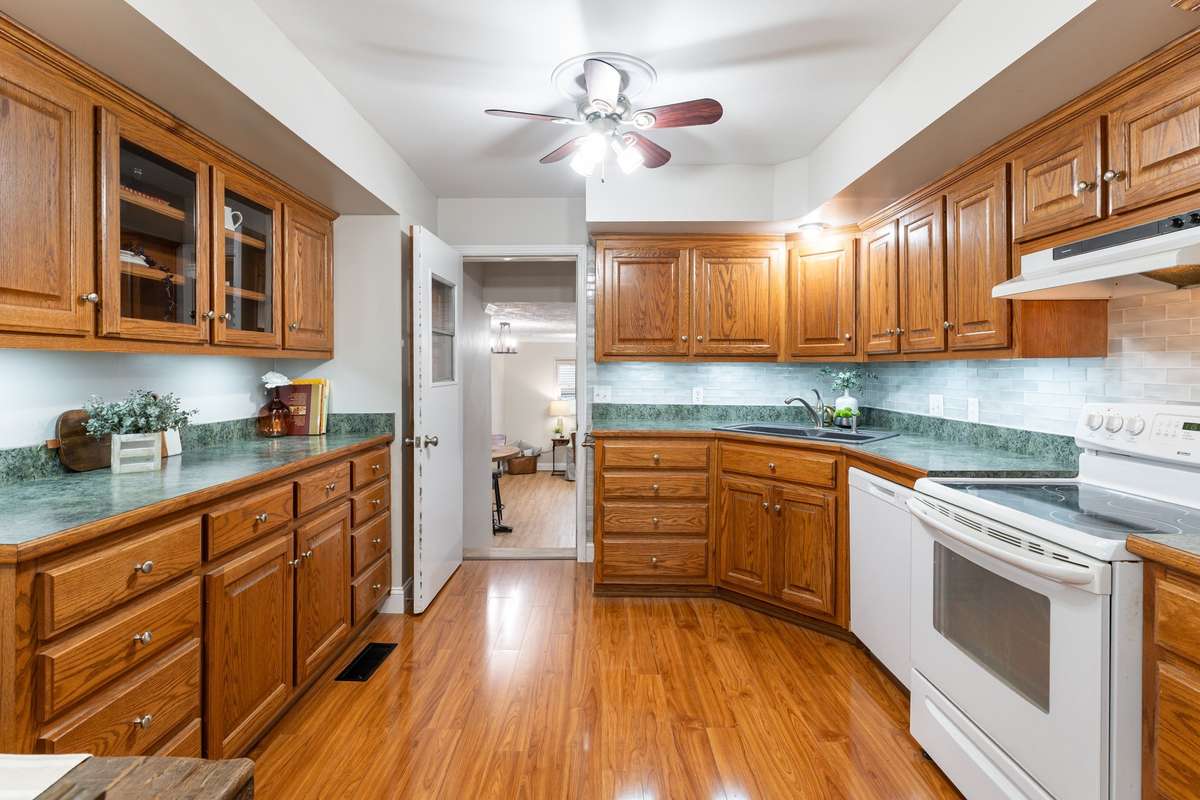 The Kitchen includes solid oak cabinetry, generous counter space, and warm hardwood style flooring