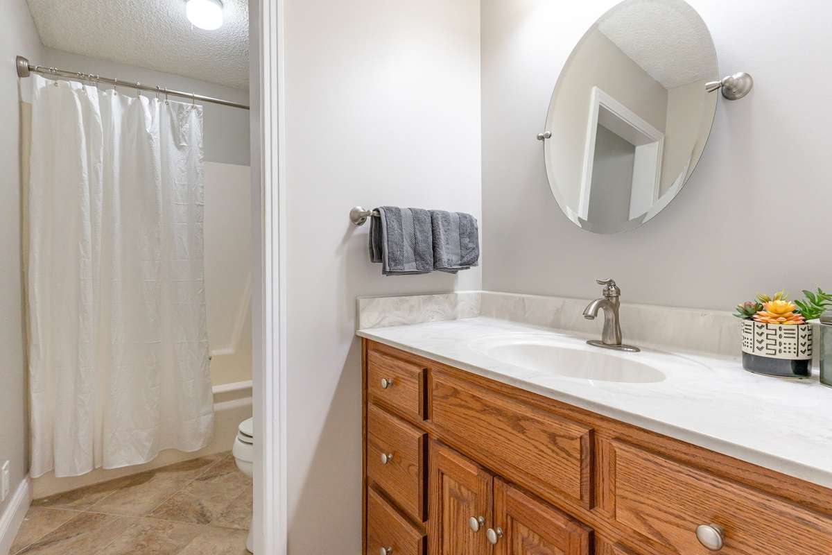 Hall Bath with a tub/shower combo offers a clean and functional layout with neutral finishes that suit any style