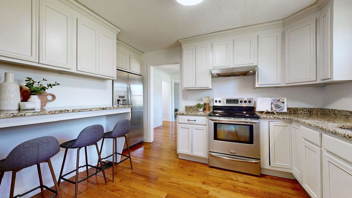 Spacious kitchen with granite countertops, bar/coffee station and plenty of cabinet space.
