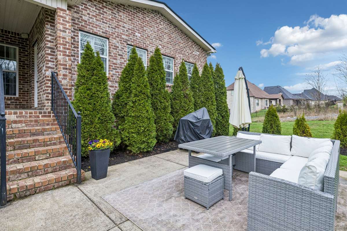 Concrete patio provides space for a grill and and outdoor dining set
