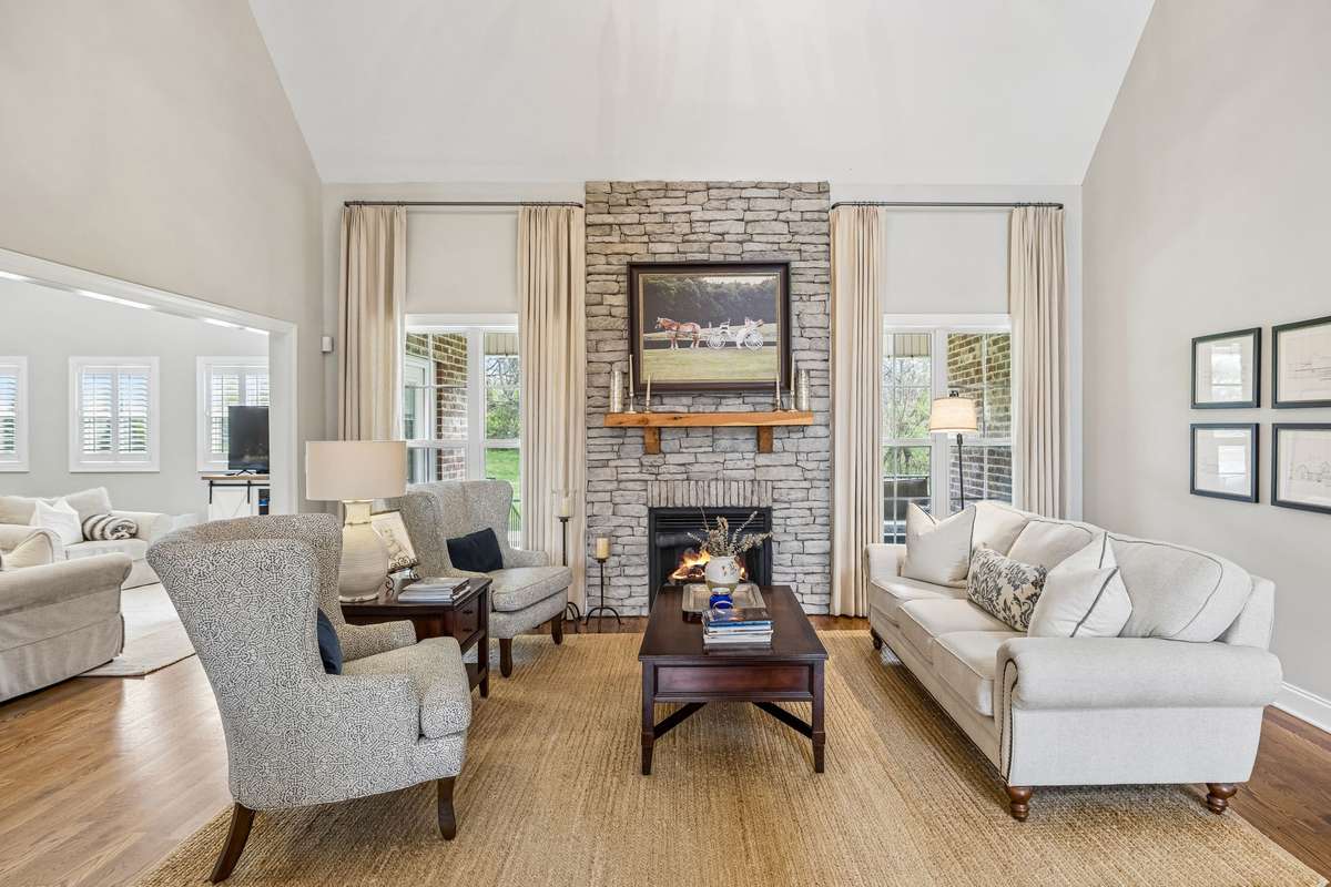 Living room with tall vaulted ceiling and gas fireplace