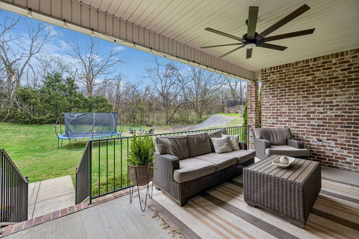 Covered back porch with wiring for an outdoor television and ceiling fan