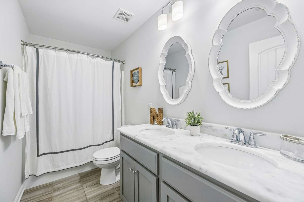 Full bathroom with tub/shower combo is shared with bedrooms 3 & 4.  This bathroom has marble countertops.