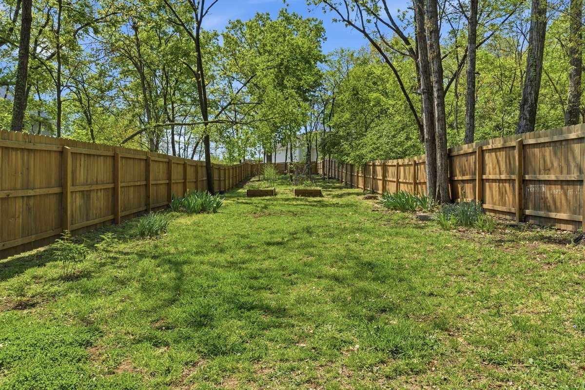Spacious backyard lawn, fully fenced.